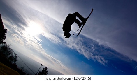 Freestyle Skier Doing A Backflip Jump Silhouetted