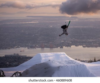 Freestyle Skier Performs Backflip Mute Grab On Jump Above City