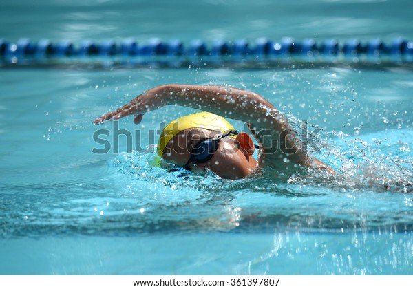 Freestyle\
swimming stroke of Kid swimmer on pool in race\
