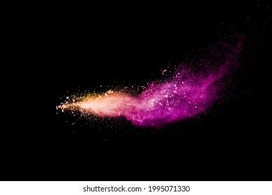 Freez Motion Of Orange Purple Dust Particle Splash.Purple Orange Color Powder Explosion Cloud  On Black Background.