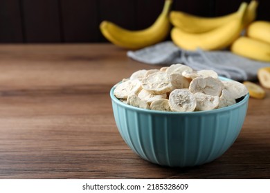 Freeze Dried And Fresh Bananas On Wooden Table. Space For Text