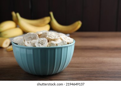 Freeze Dried And Fresh Bananas On Wooden Table. Space For Text