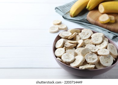 Freeze Dried And Fresh Bananas On White Wooden Table. Space For Text