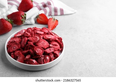 Freeze Dried And Fresh Strawberries On Light Grey Table. Space For Text