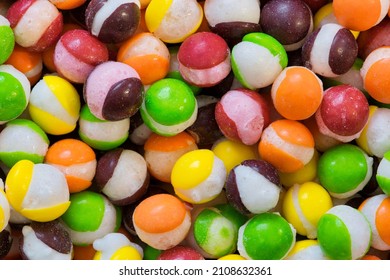 Freeze dried M and M's hard candy with splits through their centers. Colorful sweet food background.  - Shutterstock ID 2108632361