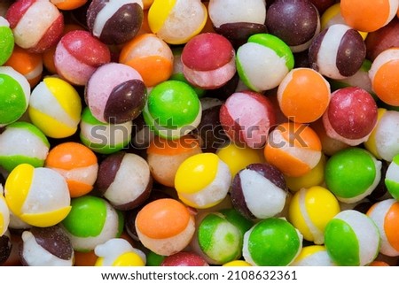 Freeze dried Skittles hard candy with splits through their centers. Colorful sweet food background. 