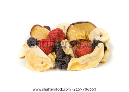 Freeze dried strawberry, blackberry, raspberry, apple, mango and banana pieces isolated over white. Top down view