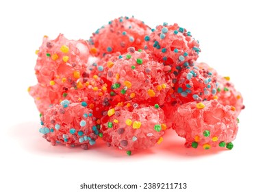 A Freeze Dried Sweet and Tangy Candy with Small Candies on the Outside of a Chewy Center on a White Background