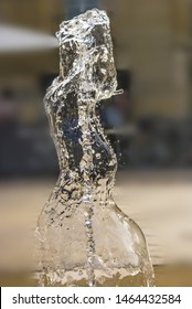 Freeze Frame Of A Water Splash From A Fountain In The Shape Of A Lady.