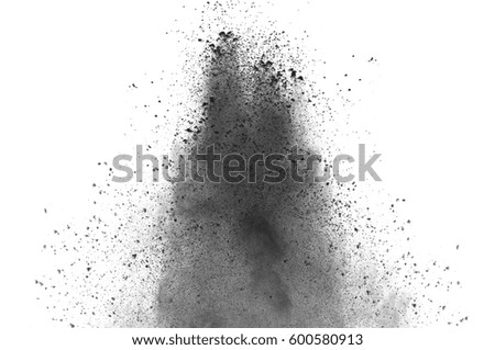 Freeze motion of black dust explosion on white background. Stopping the movement of dark powder on white background. Explosive powder black on white background.