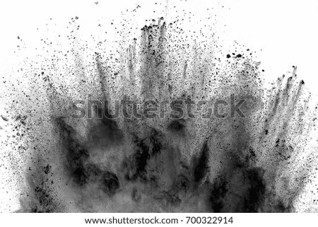 Freeze motion of black dust explosion on white background. Stopping the movement of dark powder on white background. Explosive powder black on white background.