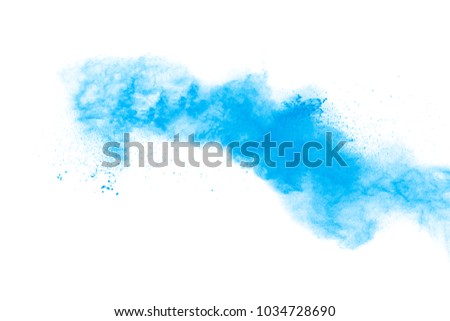 Freeze motion of blue dust explosion on black background. Throwing blue powder out of hand against black background. Stopping the movement of blue holi on the air use for abstract background.