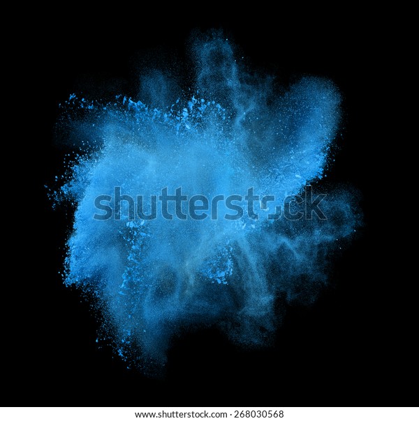 Freeze motion of blue powder exploding, isolated\
on black, dark background. Abstract design of white dust cloud.\
Particles explosion screen saver, wallpaper with copy space. Planet\
creation concept