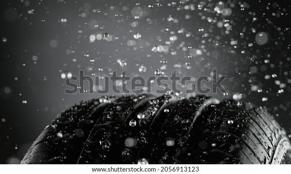 Freeze Motion of Car Tire with Water Splash,
Isolated on Black
Background