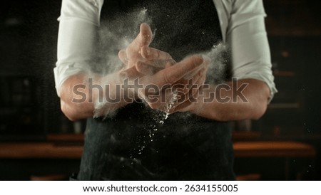 Freeze Motion Chef Clapping Hands with Flour . Closeup of Bread or Pizza Dough Preparation