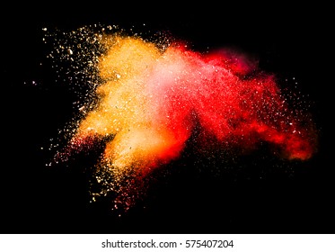 Freeze Motion Of Colored Dust Explosion Isolated On Black Background And Orange And Red Color Powder Exploding Over Black Background.