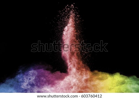 Freeze motion of colorful  painted powder exploding isolated on dark background. Abstract design of color dust cloud. Particles explosion. Splash of colorful painted powder on black background.