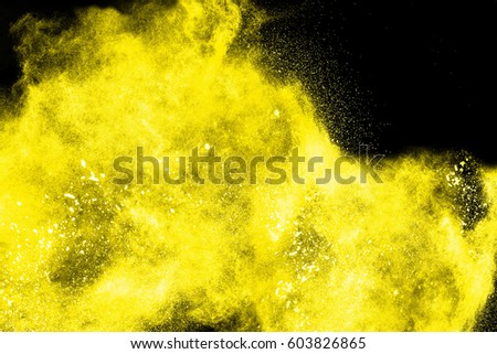 Freeze motion of colorful  painted powder exploding  on dark background. Abstract design of color dust cloud. Particles explosion. Splash of colorful painted powder on black background.