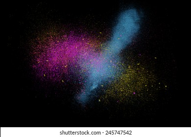 Freeze motion colorful powder exploding  isolated black  dark background  Abstract design dust cloud  Particles explosion screen saver wallpaper and copy space  Vivid yellow blue magenta ash