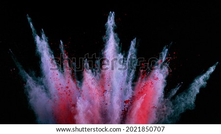 Freeze motion of coloured powder explosion. Isolated on black background.