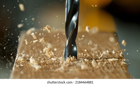 Freeze motion of a drill bit drilling into wood, macro shot - Shutterstock ID 2184464881