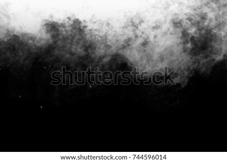 Freeze motion explosion of white dust on a black background. 