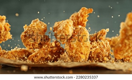 Freeze motion of flying pieces of fried chicken pieces. Concept of levitating food.