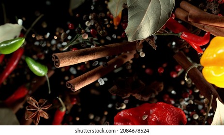 Freeze Motion Of Flying Various Kinds Of Spices Isolated On Black Background. Studio Shot.