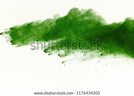 Freeze motion of Green powder exploding on white background.