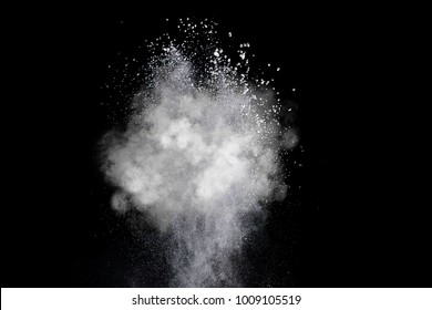 Freeze motion of heart shaped powder isolated on black background. Abstract design of dust cloud. Particles explosion screen saver, wallpaper with copy space. Love, passion, feelings concept