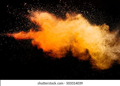 Freeze motion of orange color powder exploding on black background. - Powered by Shutterstock