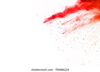 Freeze motion of red powder exploding, isolated on white background. Abstract design of red dust cloud. Particles explosion screen saver, wallpaper