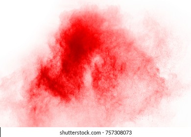 Freeze motion of red powder exploding, isolated on white background. Abstract design of red dust cloud. Particles explosion screen saver, wallpaper