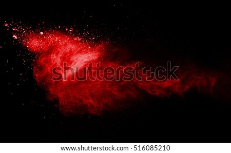 Freeze motion of red powder exploding, isolated on black, dark background. Abstract design of red dust cloud. Particles explosion screen saver, wallpaper