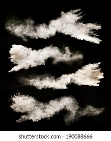 Freeze Motion Set Of White Dust Explosions Isolated On Black Background