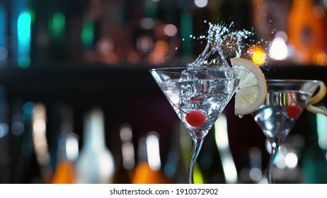 Freeze motion of splashing martini drink in bar. Free space for text