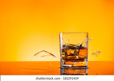 Freeze Motion Of Whiskey Drink With Boken Piece Of Glass