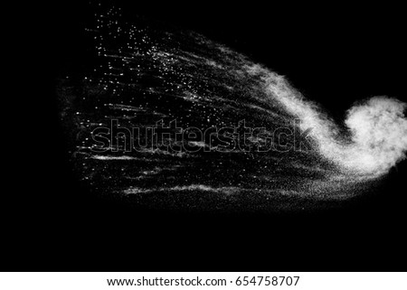 Freeze motion  of white dust explosion on  black background.