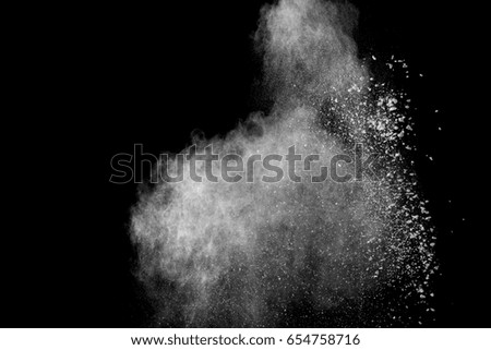 Freeze motion  of white dust explosion on  black background.