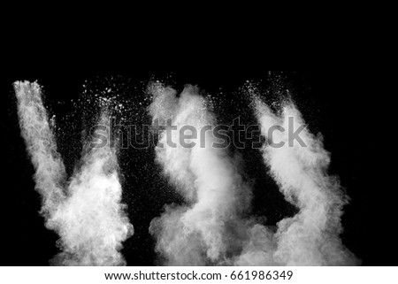 Freeze motion of white dust explosion  isolated on black background.