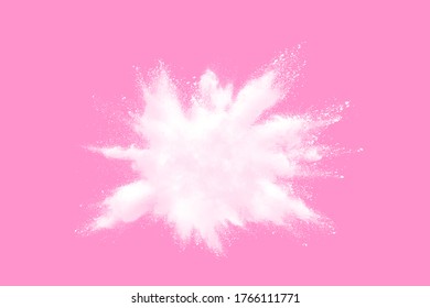Freeze motion of white dust particles splash on pink background.White powder explosion clouds.