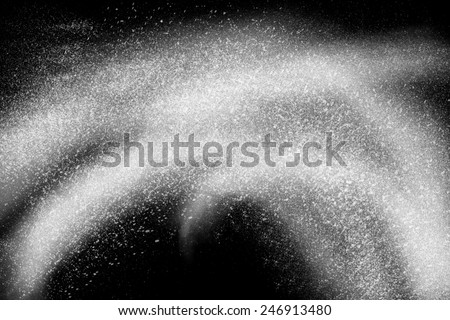 Freeze motion of white powder exploding, isolated on black, dark background. Abstract design of white dust cloud. Particles explosion screen saver, wallpaper. Planet creation concept