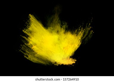 Freeze Motion Of Yellow Dust Explosion Isolated On Black Background