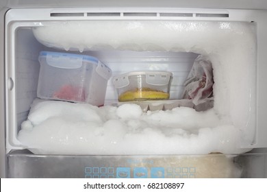 Freezer Of Refrigerator With Ice And Food In Shelf.