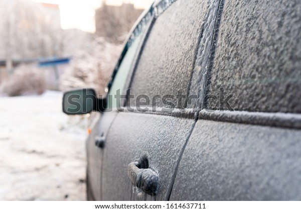 It\'s freezing rain. A car covered in ice after an\
ice storm.