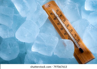 Freezing Temperatures And Cold Weather Concept With A Vintage Thermometer Surrounded By Blue Ice Showing Sub Zero Temperature With Copy Space