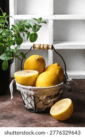 Freh whole and sliced lemons in rustic wire basket