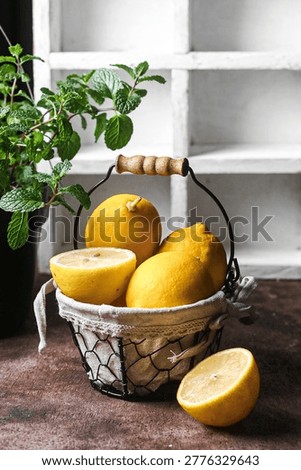 Freh whole and sliced lemons in rustic wire basket