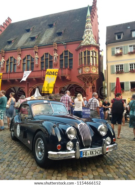 FREIBURG, GERMANY - AUGUST 3, 2018: A 1958 Jaguar\
XK140 Coupe is parked after finishing at the Schauinsland Klassik\
2018 classic car\
rally.