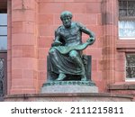 Freiburg im Breisgau, Germany. Aristotle Statue in front of the main building of Freiburg University. The statue was erected in 1921. Greek text on plinth means Aristotle.